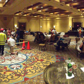 Group of people sitting at round tables in a banquet hall.