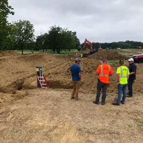 Trench with a ladder in it.