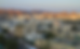 View of the city of Muscat with mountains in the background while the sun sets.