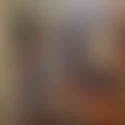 A cluttered closet with clothing and shoes and random items covering the floor