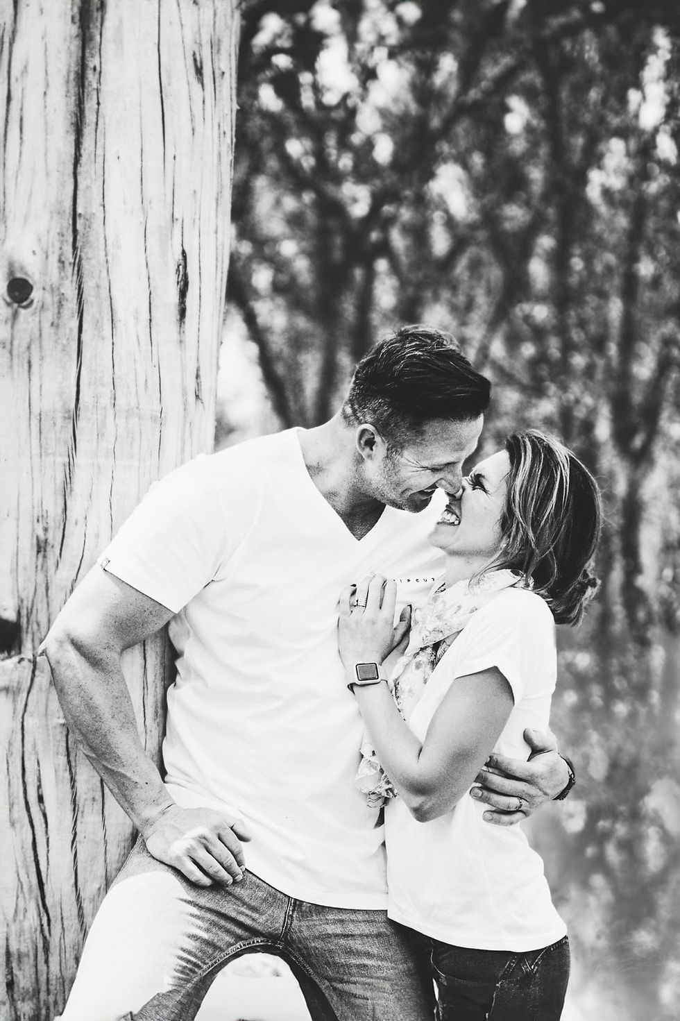 Couple embracing during a book photography session outdoors.