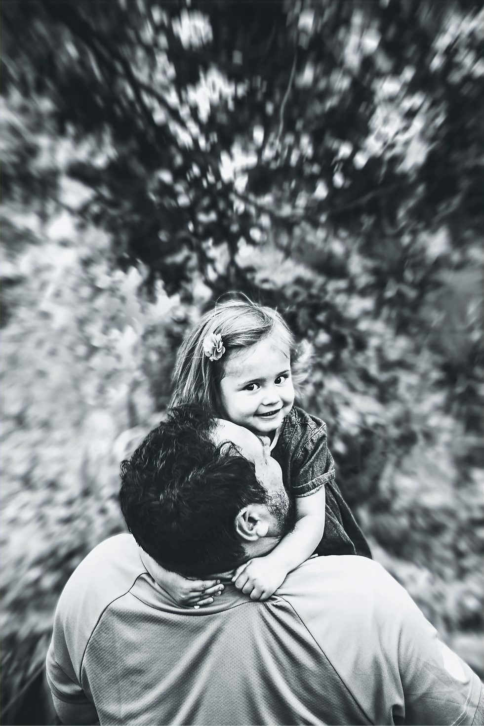 Young girl hugging father during a book photography session