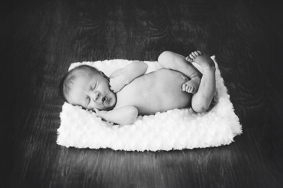 Sleeping newborn captured during a book photography session.