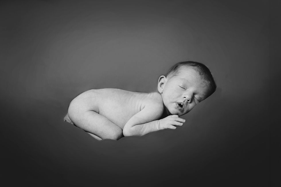 Sleeping newborn in a b&w book photography session