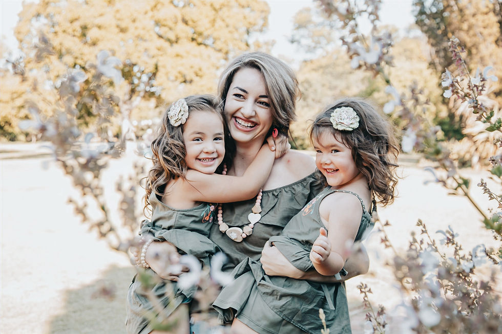 Smiling mother and two daughters in a book photography session