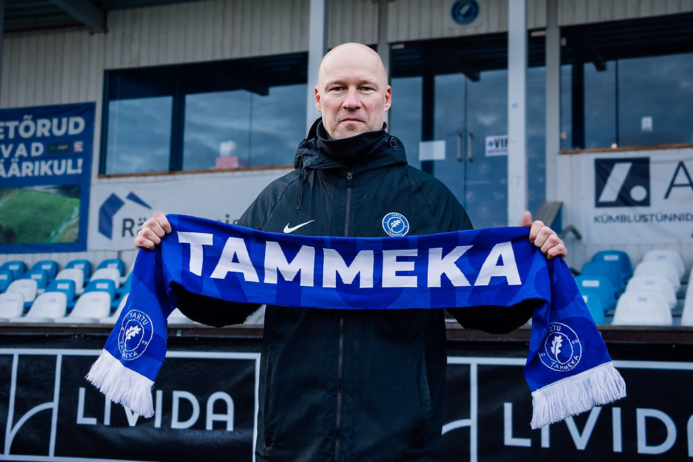 JK Tammeka's new head coach Karel Voolaid holding a JK Tammeka scarf at the Coop Stadium in Tartu