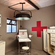 Vintage medical examination room: chair, light, cross