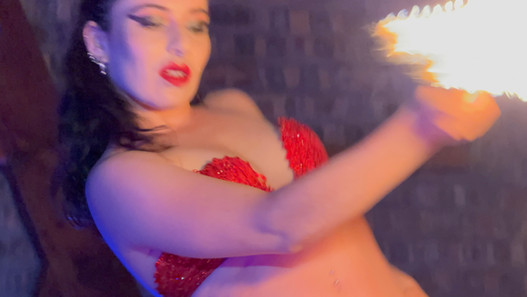 Woman in red performing fire dance