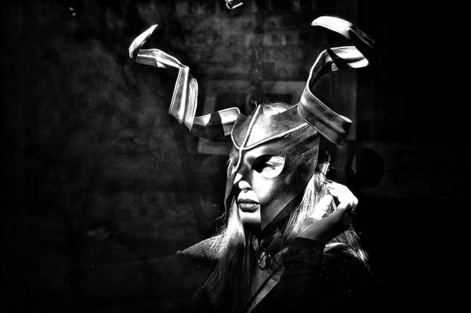 Dramatic portrait of person in horned mask, suitable for discipline photography