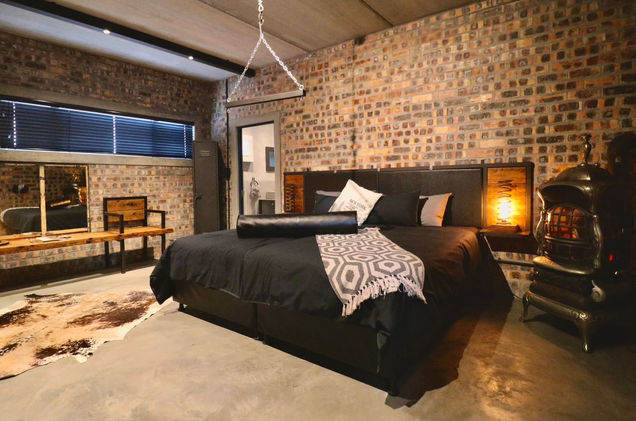 Fetish playroom with black bed and suspension triangle