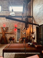 BDSM guest house dungeon: leather restraints, wooden cross, chains