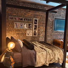 Luxury four-poster bed in an intimate adult play space, Cape Town