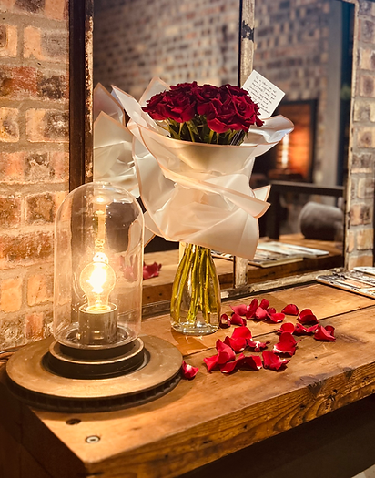 Red roses bouquet, romantic setting