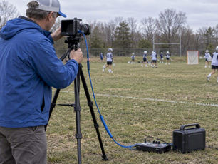 Parent checking hardwired sideline camera setup