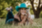 Beautiful cowgirl with her dog