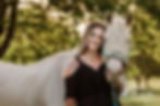 Woman standing with horse.