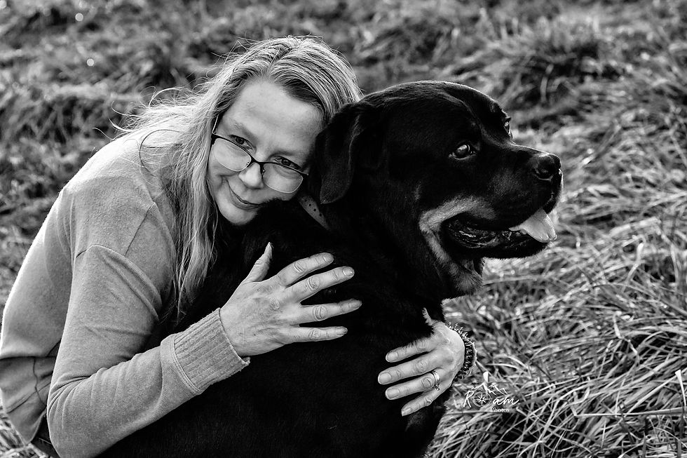 Woman hugging her Rottweiler dog