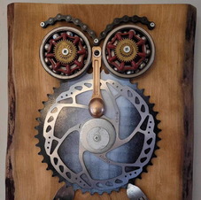 various metal findings made into artwork and mounted on wood