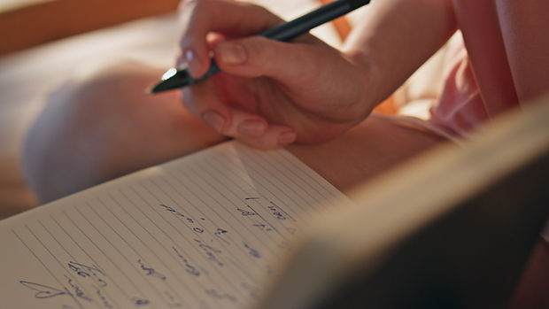 hand-making-handwriting-notes-closeup-girl-holdin-2024-11-05-03-14-42-utc.jpg