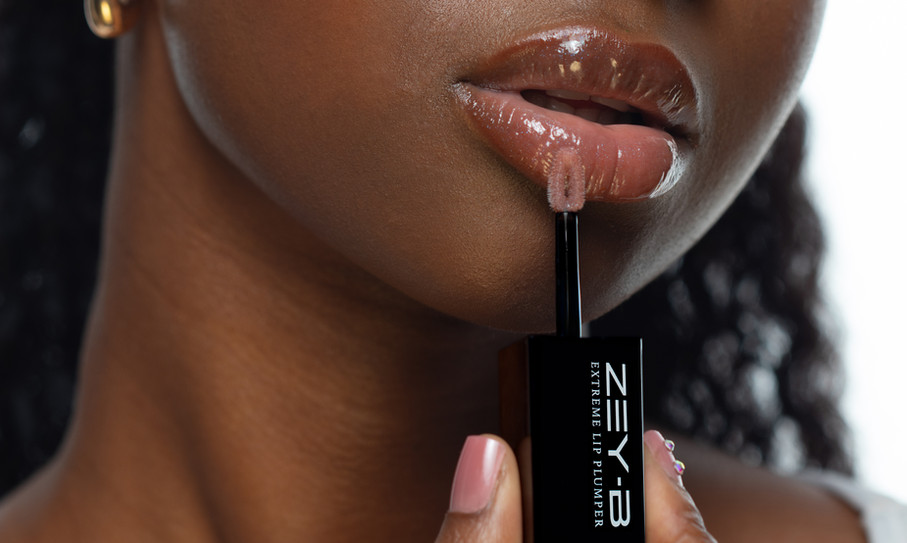 Girl applying lip gloss