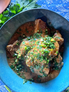 A bowl of Summer Beef Stew topped with Citrus-Herb Gremolata