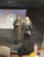 Two people on-stage giving a lecture