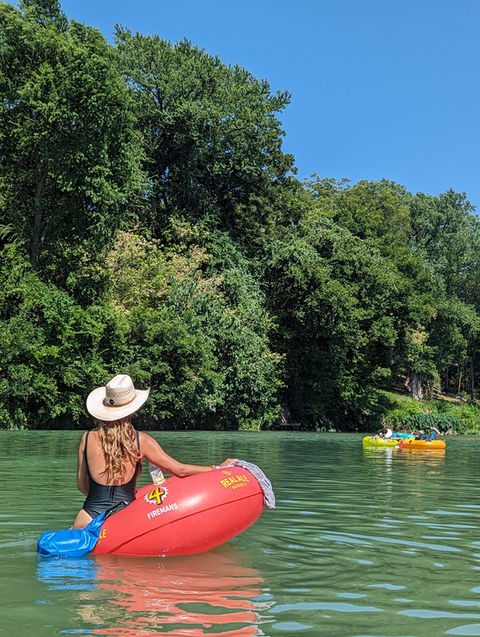 A Cowgirl floats and enjoys the sun