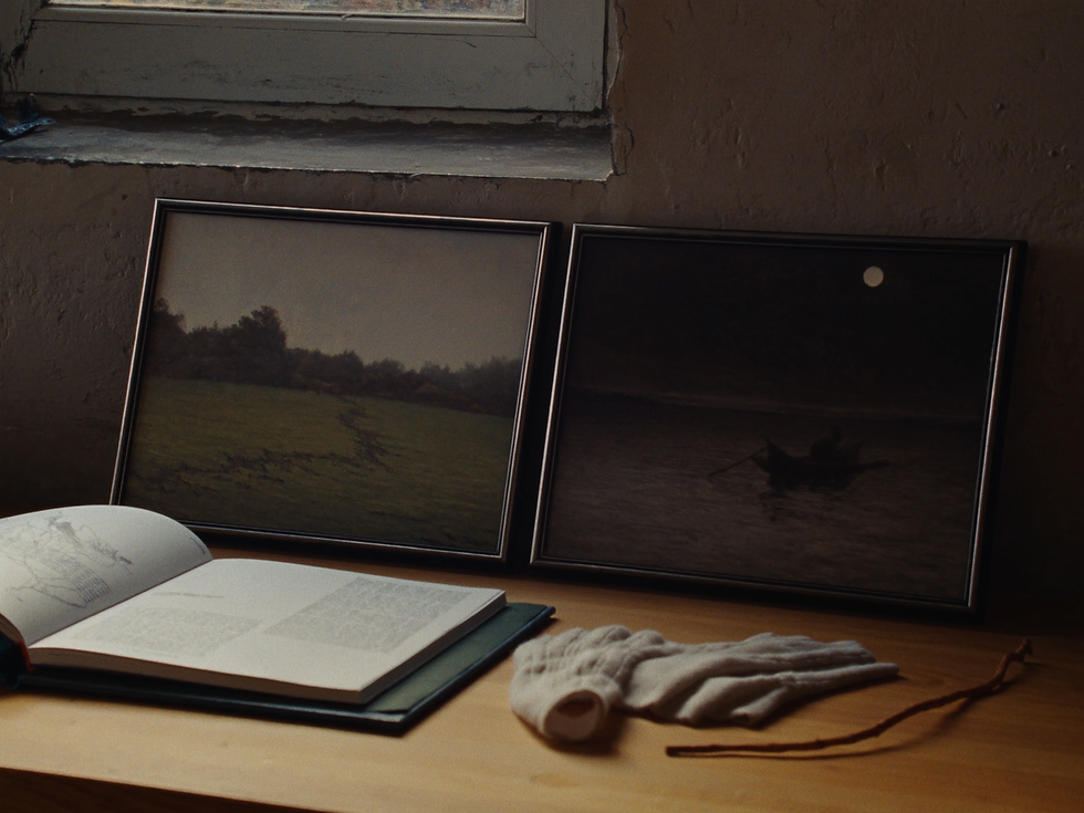 Small storytelling wall art prints arranged on an oak collector table