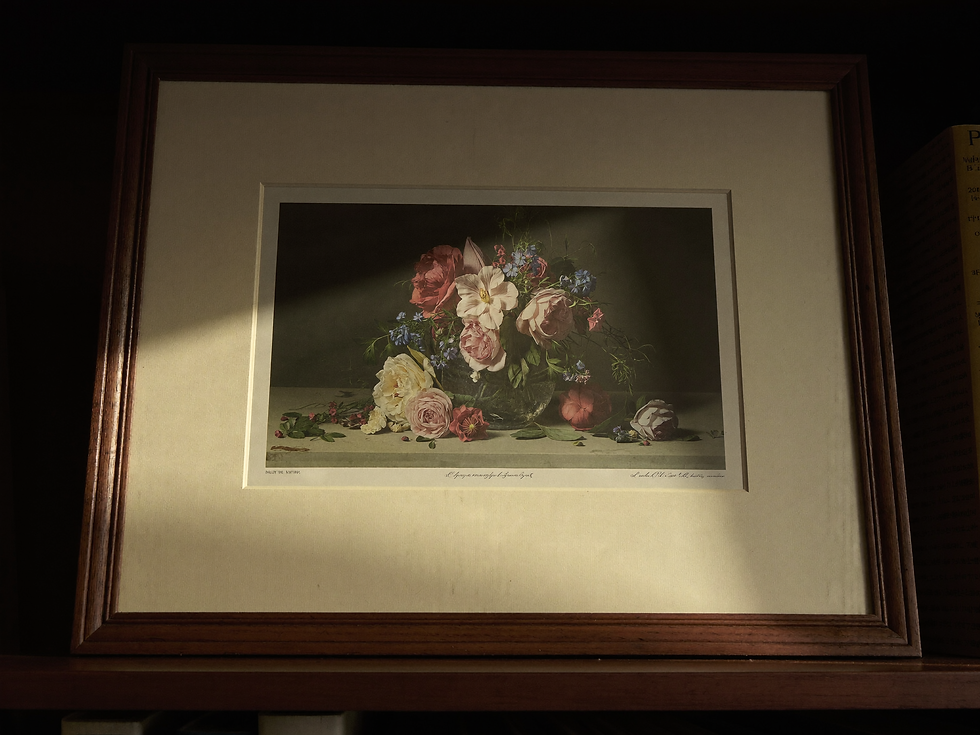 A floral art print surrounded by a generous cream mat inside a dark wooden frame.