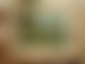 Pastoral landscape print surrounded by an ivory mat inside a wooden frame.