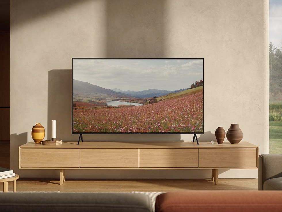 Landscape artwork displayed on a slim Frame TV in a softly lit living room.