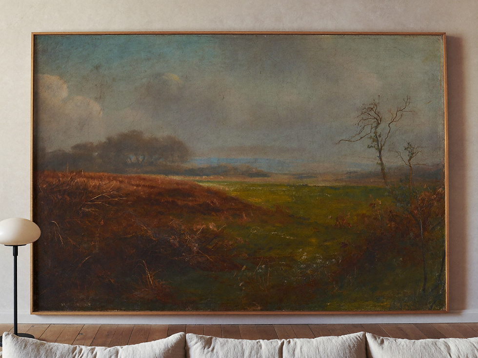 Large misty countryside painting above a linen sofa in a refined vintage living room.