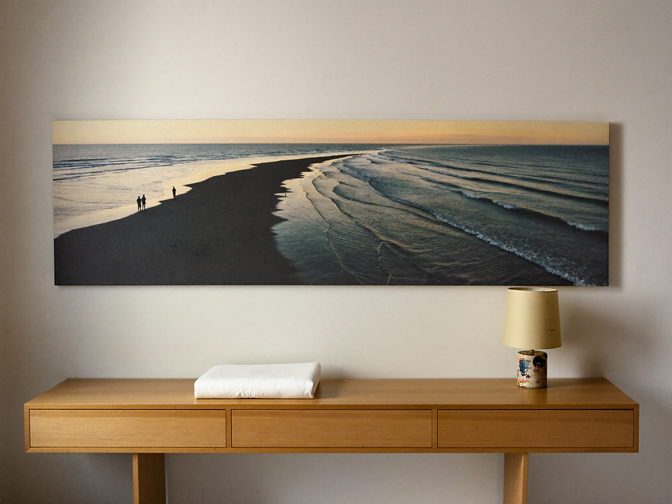 Wide coastal artwork with an open horizon above a simple console.