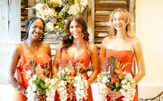 smiling bridesmaids holding there bouquet of flowers