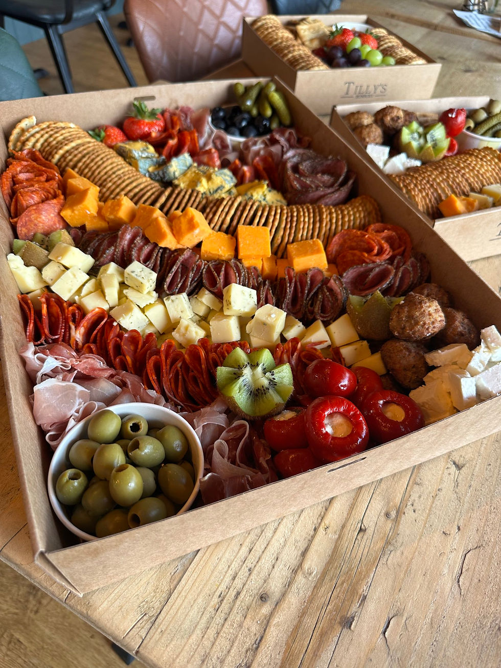 Boxed filled with cured meats, cheeses, fruits and crackers 