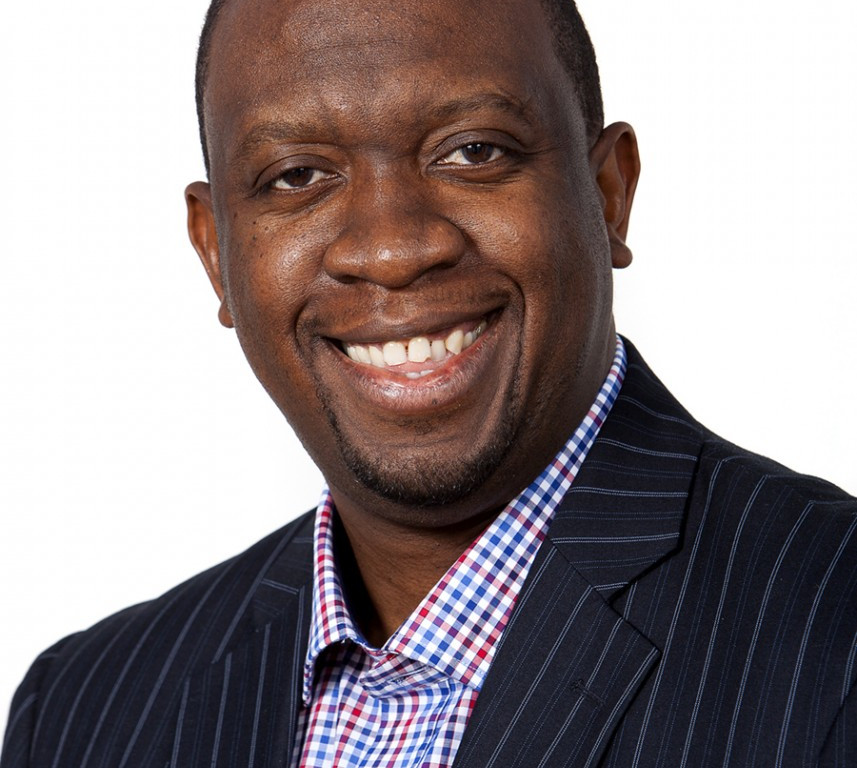 Smiling man in suit and patterned shirt