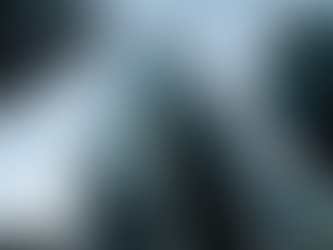 Skyscrapers with geometric patterns rise against a clear blue sky. Reflections on glass create a modern, urban atmosphere. Aesthetic photograph of NYC skyscrapers representing the surge in real estate and office leasing by firms like JPMorgan and Goldman Sachs, highlighting the role of space management, space planning, and office management software such as desk booking and scenario tools in shaping the modern workplace.