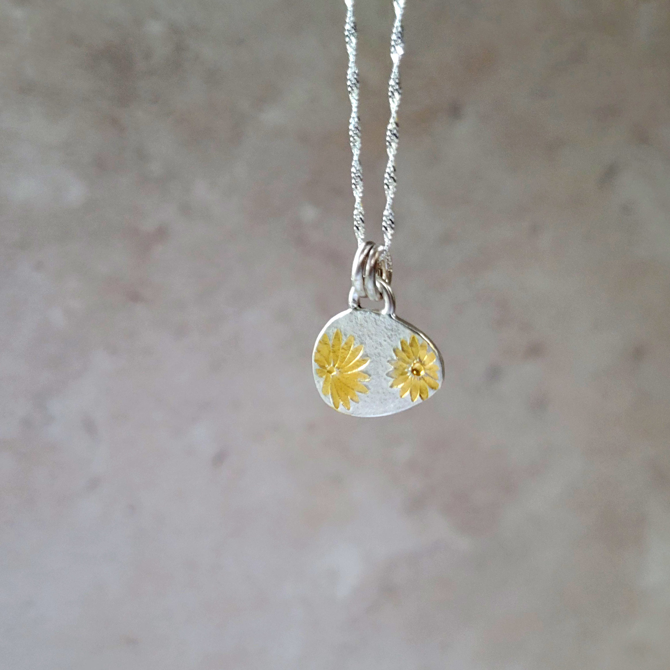 silver and gold pendant