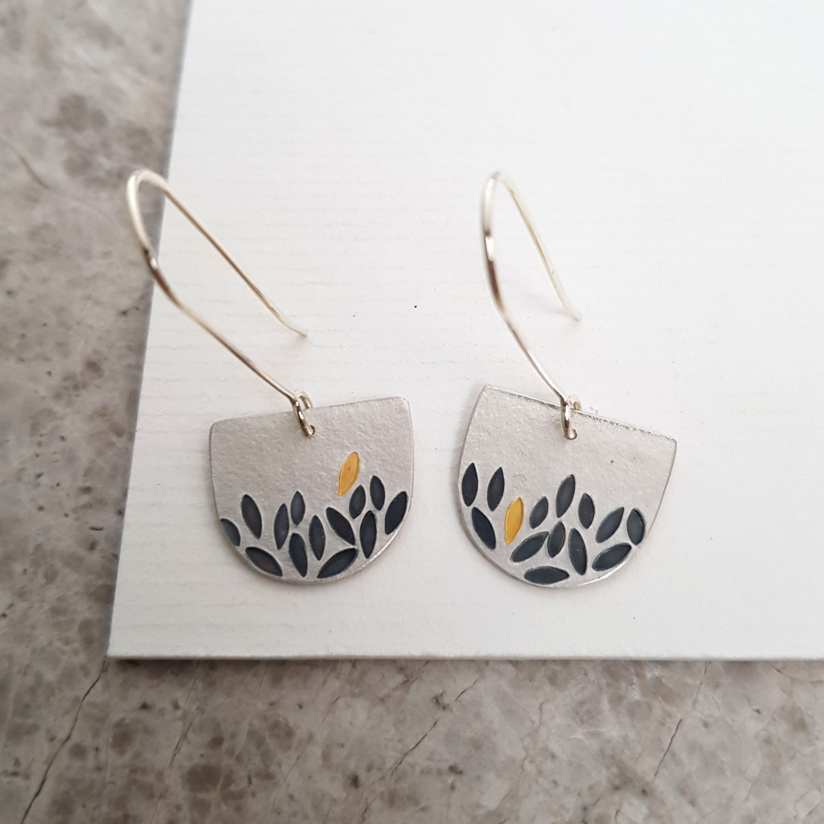 solid silver handmade dangle earrings with gold leaf