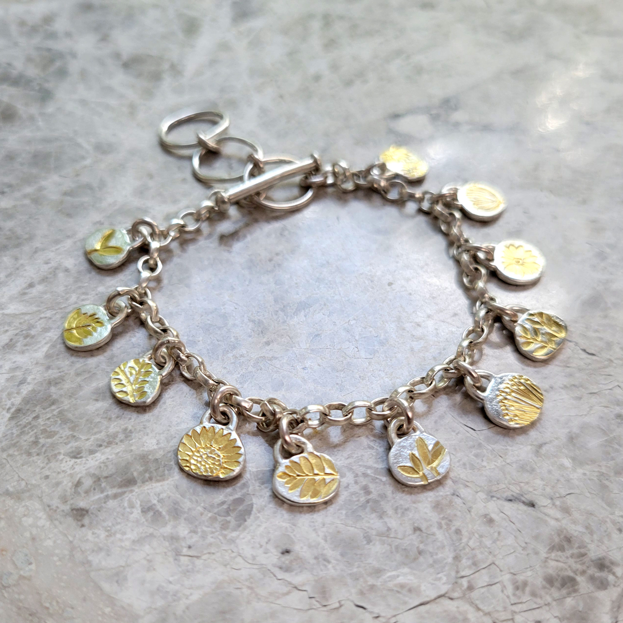 silver and gold charm bracelet