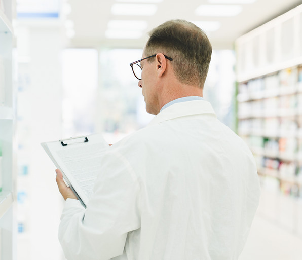 chemist-checking-medical-prescription-on-clipboard-2022-01-12-22-31-35-utc.jpg