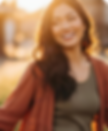 Woman smiling with sunset background