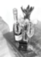 A Leucadendron flower with Royal Albert champagne flutes with Swarovski crystals embedded into heart etchings and an ring with a sparkling stone in it
