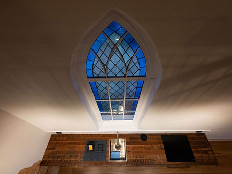 A lead light window with a oregon pine kitchen bench with a sink and a tap