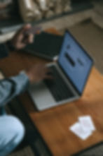 Man making an online purchase on his laptop while holding a credit card