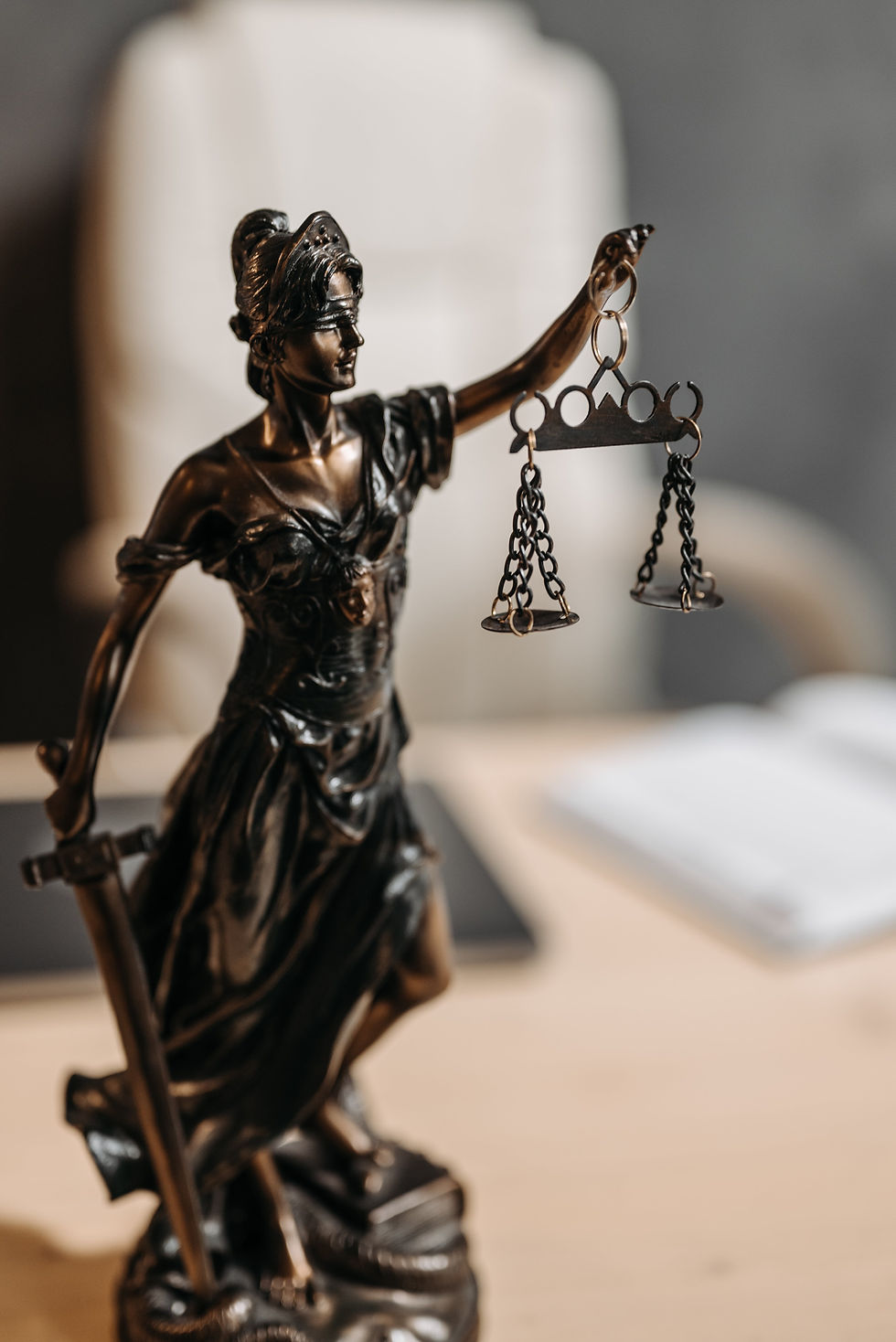 Legal statue holding scales of justice