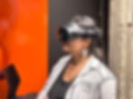 Woman wearing VR headset, using laptop