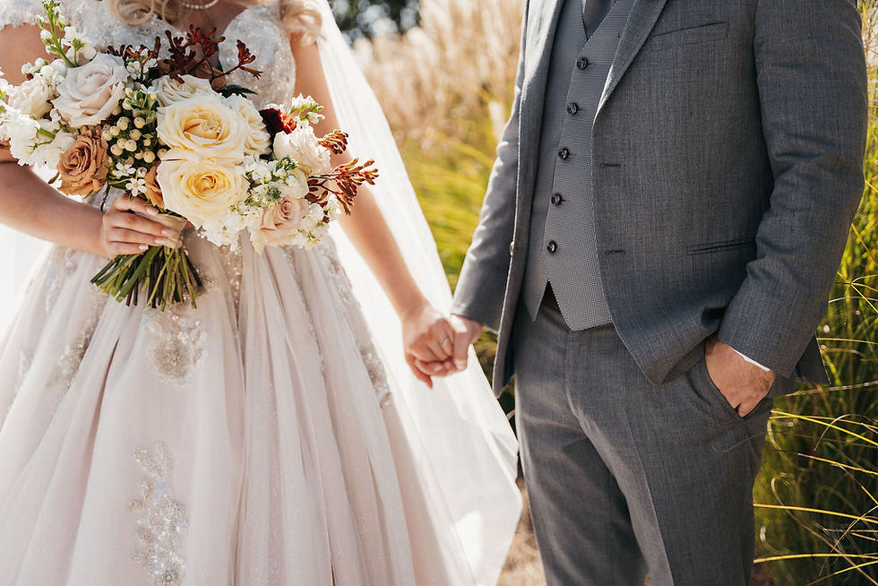 bride and groom holding hands zoomes in to show dress and tux