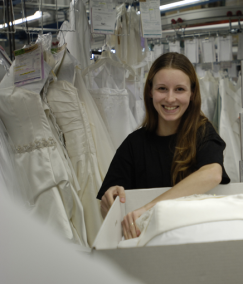 a wedding gown preservation employee boxing up a brides wedding gown