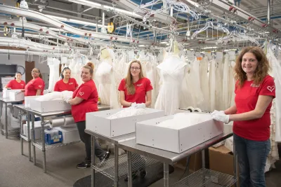 workers working on preserving brides wedding gown